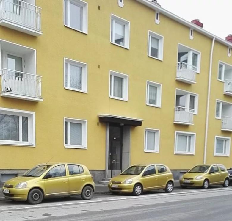 3. Sarı renkteki bir binanın önünde park etmiş araçların hepsi aynı renk, aynı model, aynı marka...